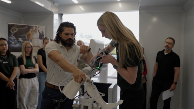 Matilda Capes, a student at Fossil Ridge High School, tries a knee replacement demonstration using robotic surgical technology. 
