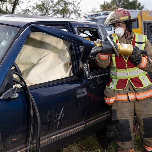 Firefighter Opening Truck Door with Extricator