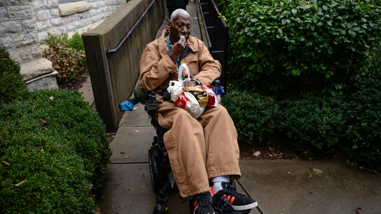 Brock Brooks, a disabled Marine Corps veteran, cries while describing the impending SNAP shutdowns while waiting in line to enter the food pantry service at Calvary Episcopal Church on Oct. 30, 2025, in Louisville, Ky. 