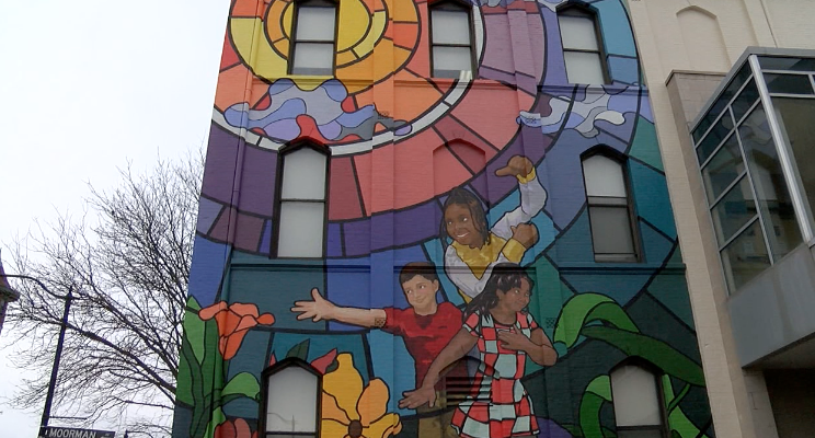 ’Together We Win’ painted on the St. Francis De Sales school in Walnut Hills by artist Brandon Hawkins