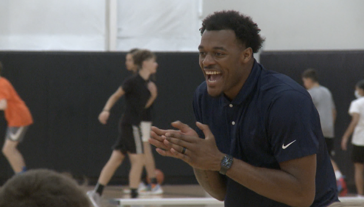 Xavier Tillman smiles during camp drills