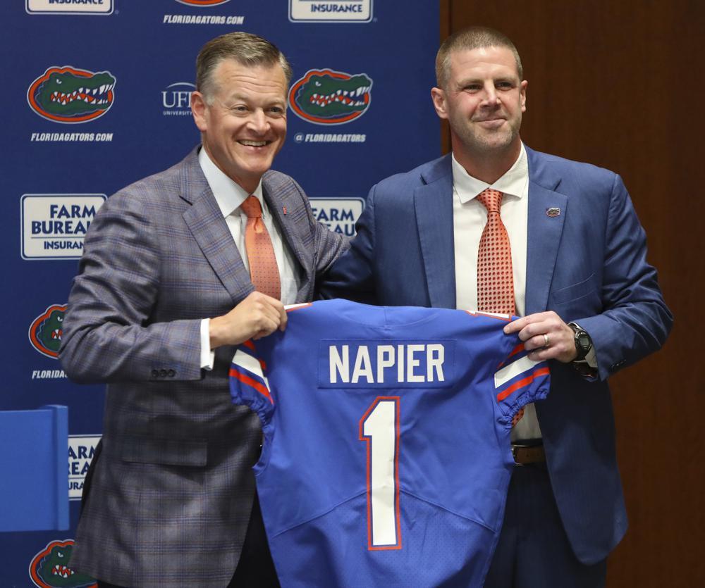 Florida Gators athletic director Scott Stricklin and head coach Billy Napier hold Gators jersey during Napier's introductory news conference, Dec. 5, 2021