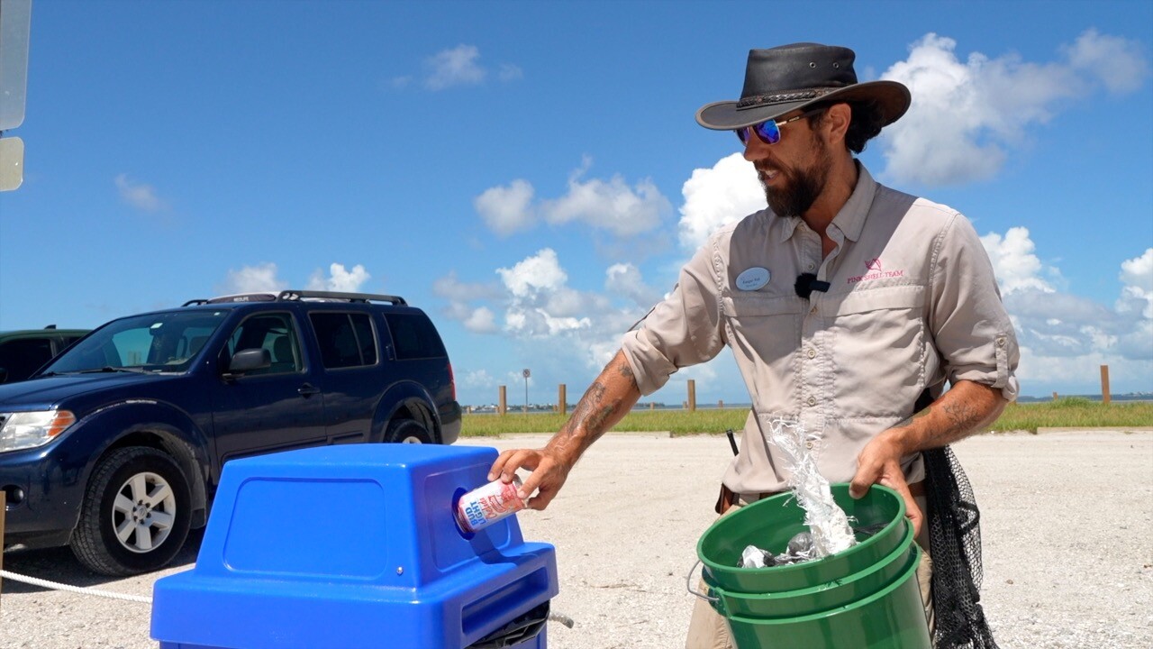 Ranger Rob Howell recyling a picked up can