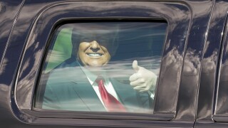 President Donald Trump gives thumbs up to supporters on motorcade route to Mar-a-Lago, Jan. 20, 2021