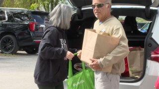 Members of the Good Shepherd Episcopal Church in Tequesta distribute food to a resident in need on Nov. 11, 2025.