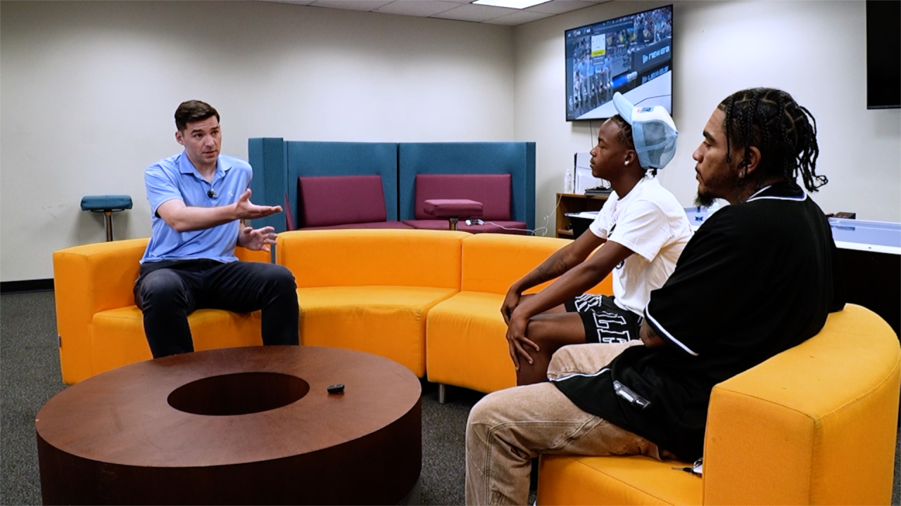Denver7's Ryan Fish asks a question during an interview at the Love Center in Montbello.