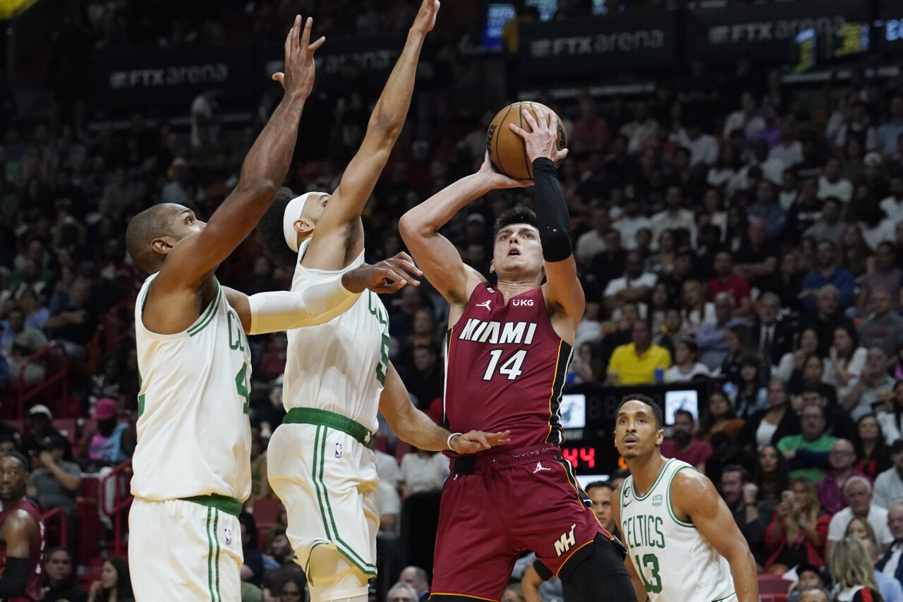 Miami Heat guard Tyler Herro drives to basket as Boston Celtics guard Derrick White and center Al Horford defend, Oct. 21, 2022