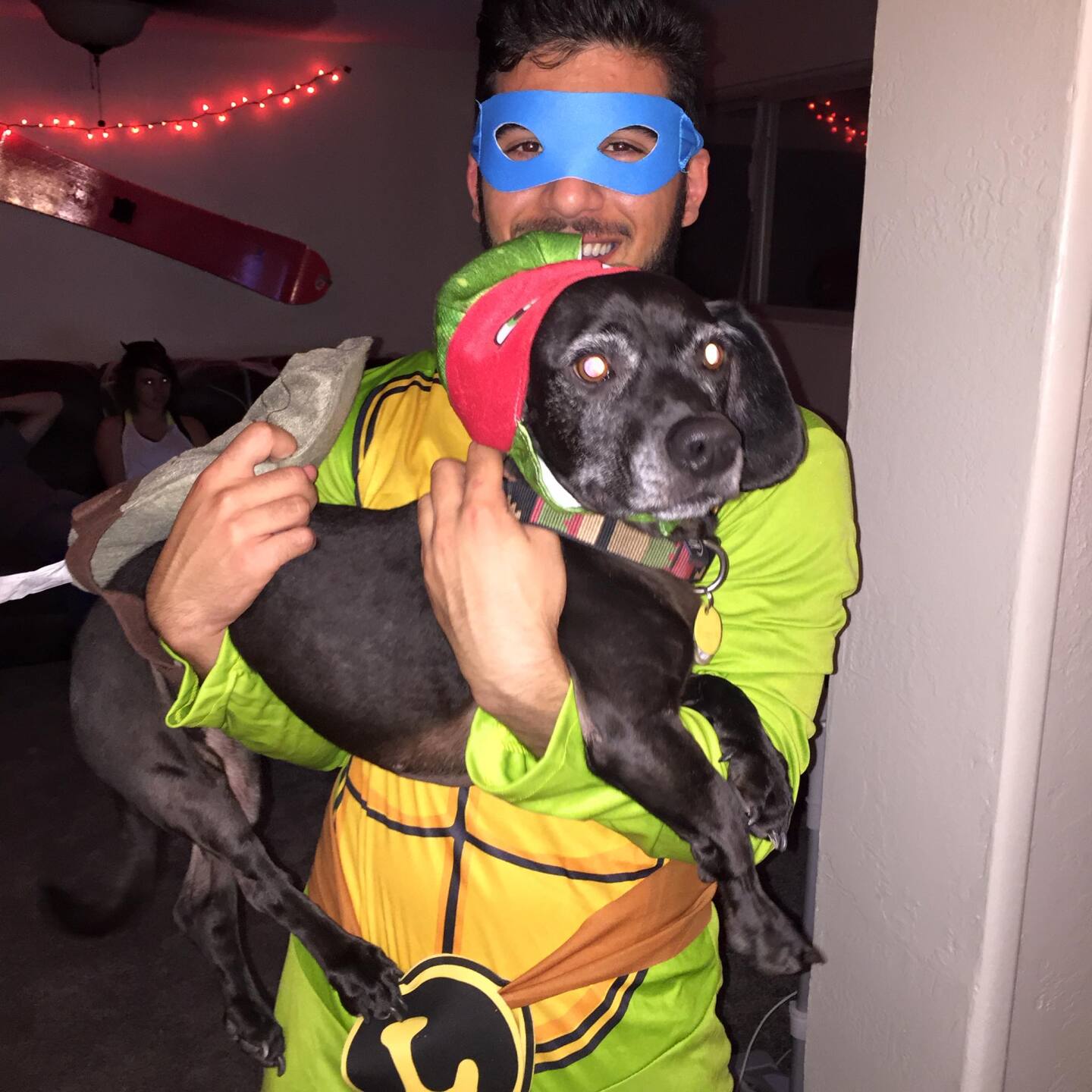 Jared Levin and dog Hank dress up as Ninja Turtles for Halloween.