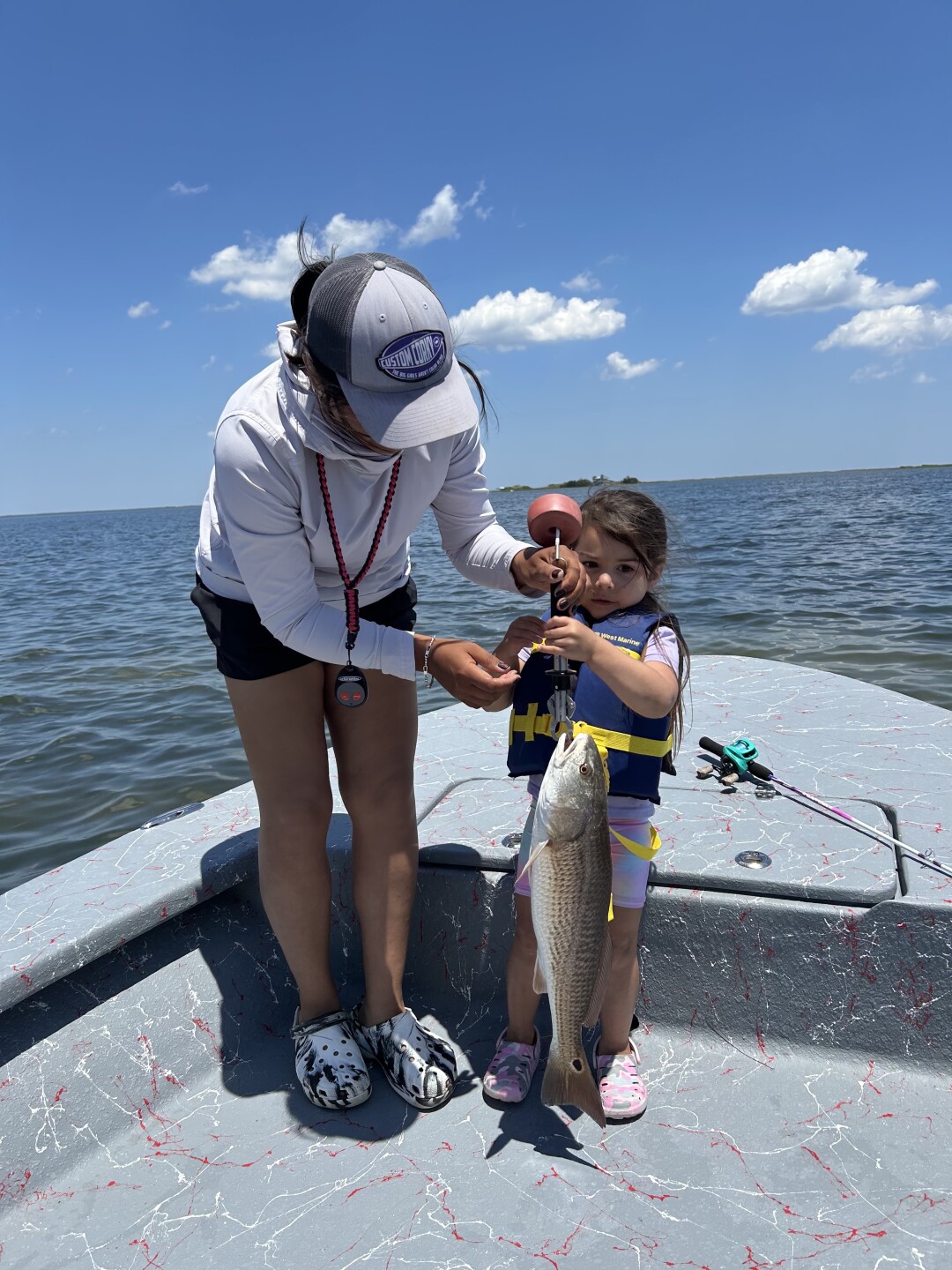 Captain Reanna Delacruz and her daughter catch a redfish on Mother’s Day
