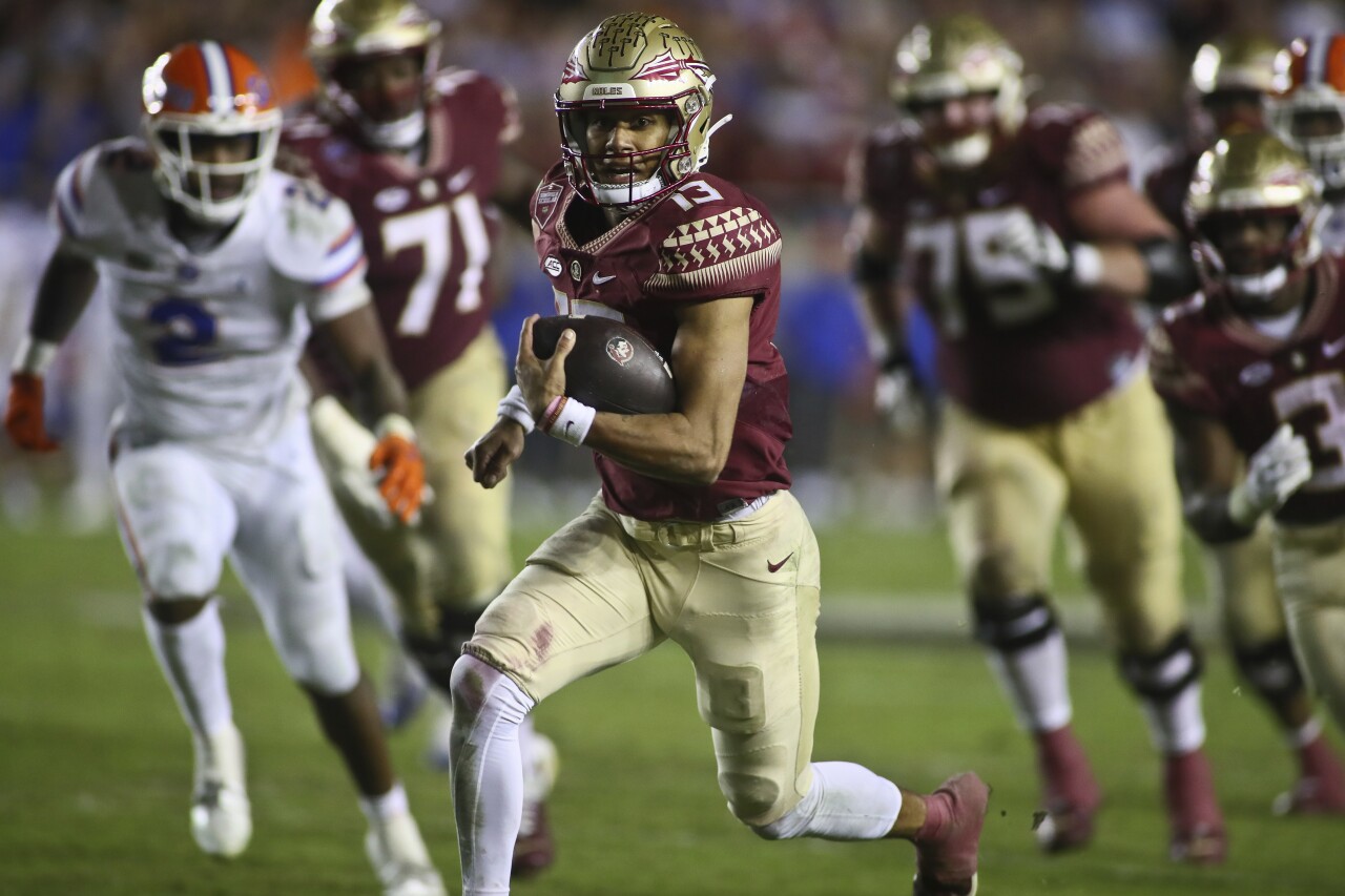 Florida State Seminole QB Jordan Travis running in the fourth quarter against the Florida Gators on November 25, 2022