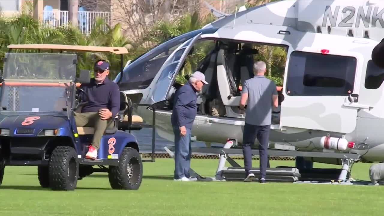 Florida State Seminoles head coach Mike Norvell steps into helicopter as Benjamin Buccaneers football coach Eric Kresser drives away in golf cart, Feb. 1, 2024