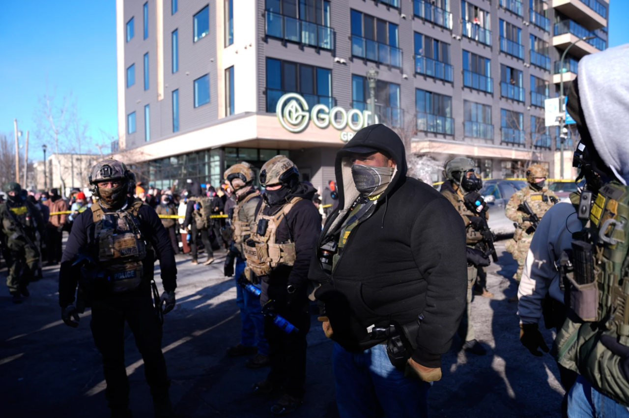 Federal agents stand near the site of a shooting Saturday, Jan. 24, 2026, in Minneapolis, Minn.