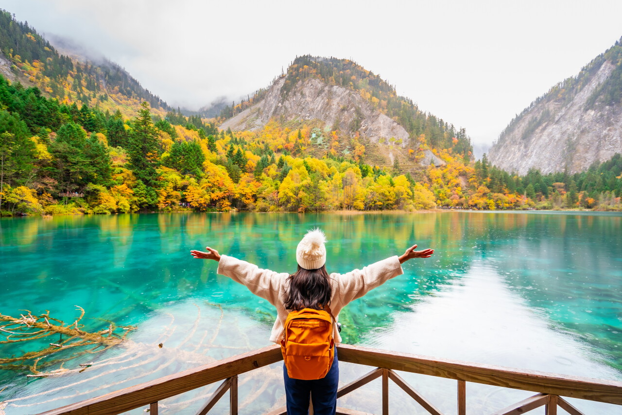 Young,Female,Tourist,Looking,At,Beautiful,Autumn,Scenery,Landscape,At
