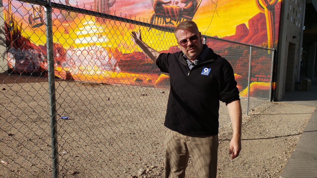 KGUN 9's Don Davis at site of vandalized Joe Pagac mural downtown.