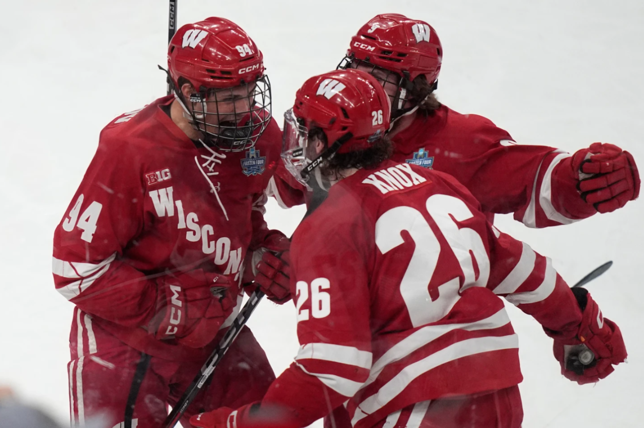 Wisconsin forward Vasily Zelenov, left, celebrates after scoring against Denver in the first period of the championship game at the NCAA Frozen Four men's college hockey tournament Saturday, April 11, 2026, in Las Vegas.