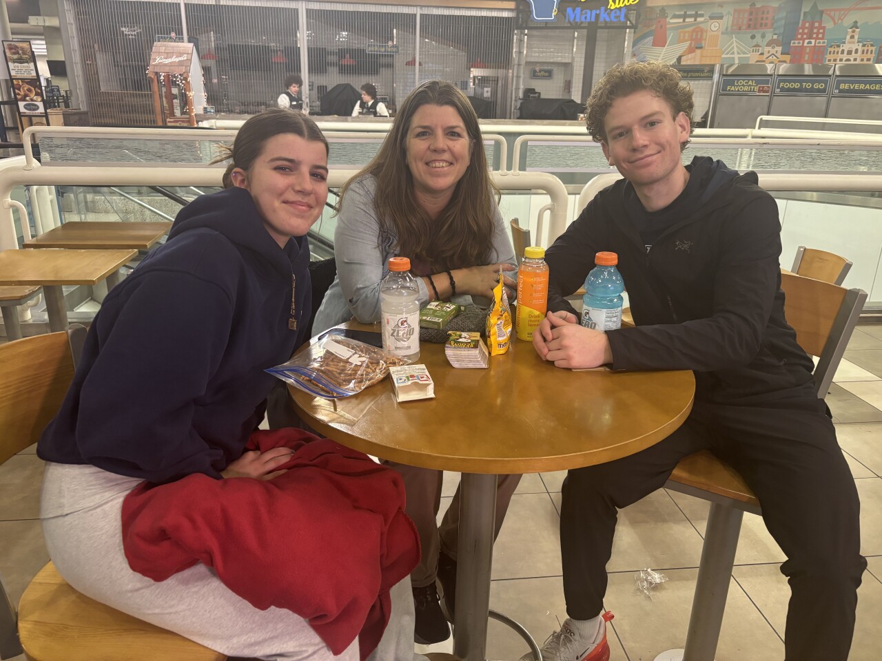 Riohlan, Jennifer and Kiernan McKeegan wait for their delayed flight to take off at Milwaukee Mitchell International Airport following Thanksgiving in Wisconsin