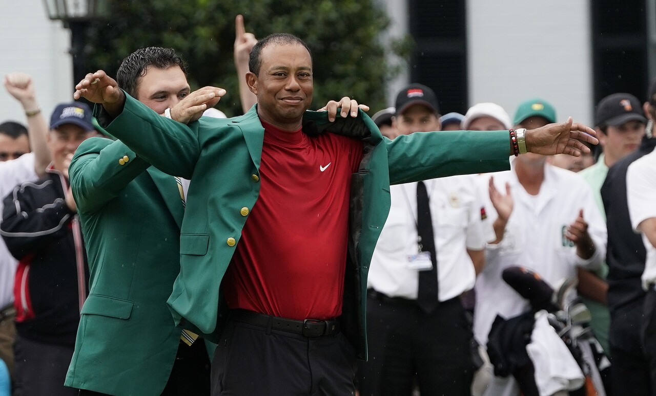 Patrick Reed helps Tiger Woods put on green jacket after winning 2019 Masters