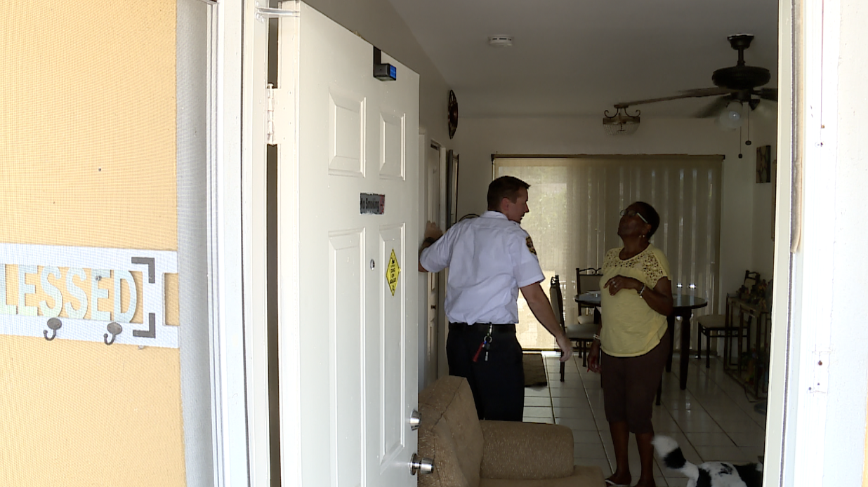 Ival Lowe, 84, lets Delray Beach Fire-Rescue install lockbox on her door