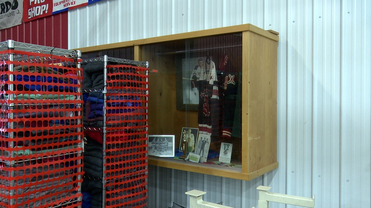 A display case with two of Casey's jerseys and pictures of Casey is mounted on the wall inside the Great Falls Ice Plex