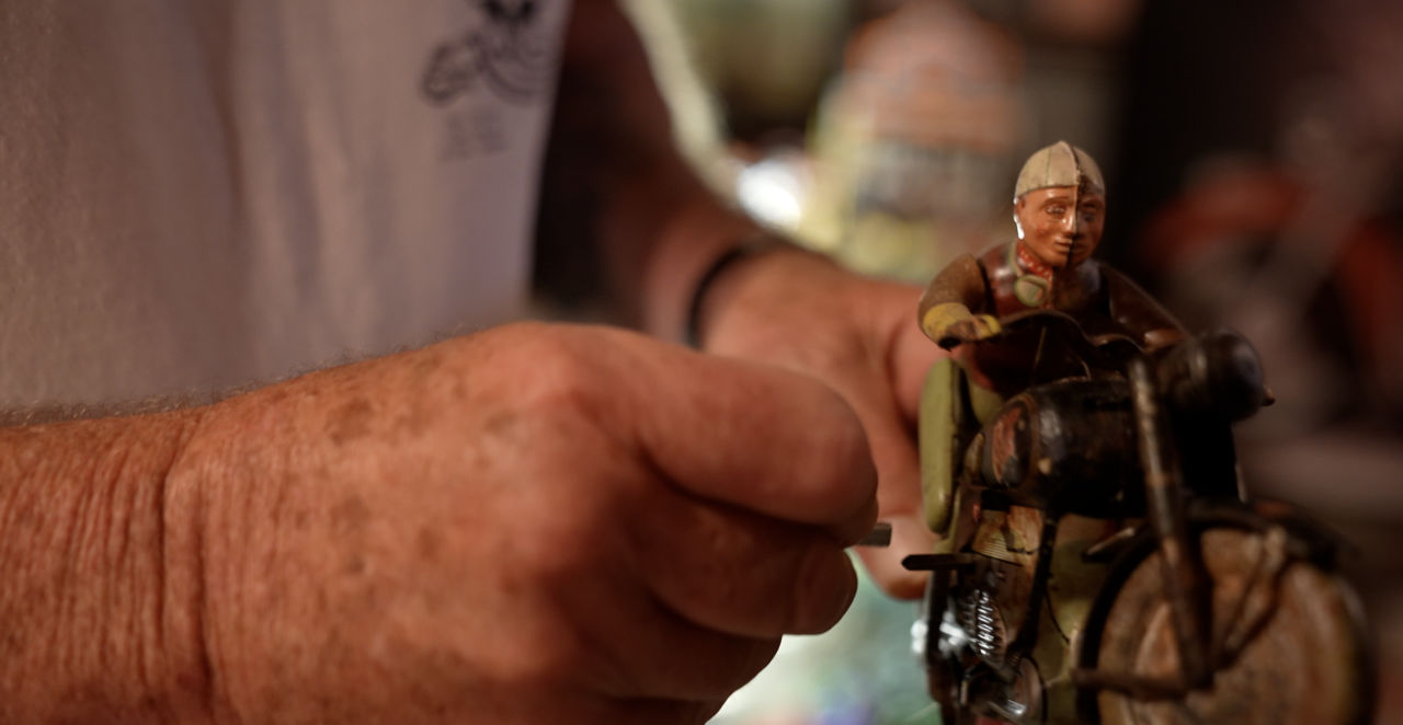 Wayne is winding up one of the toys.