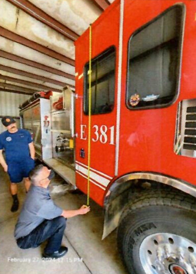 An ADOSH inspector examines the cab of the fire engine at the Gila Bend Fire Station after the February accident. Credit: ADOSH