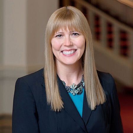 Meghan Cummings is the executive director of the Women's Fund of the Greater Cincinnati Foundation. She has long, strawberry blonde hair and is wearing a turquoise blouse and dark jacket in this portrait.