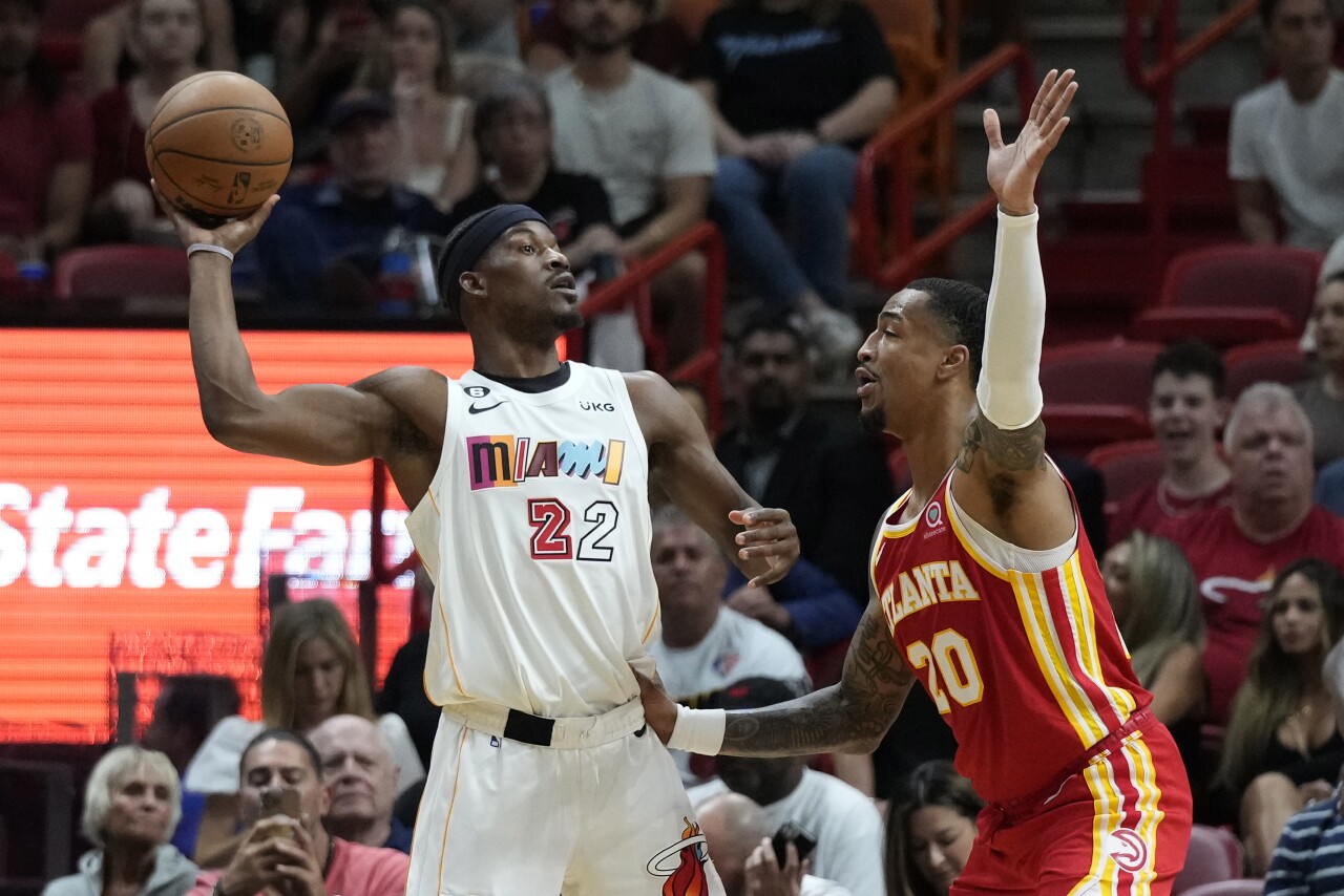 Miami Heat forward Jimmy Butler tries to pass against Atlanta Hawks forward John Collins, March 6, 2023