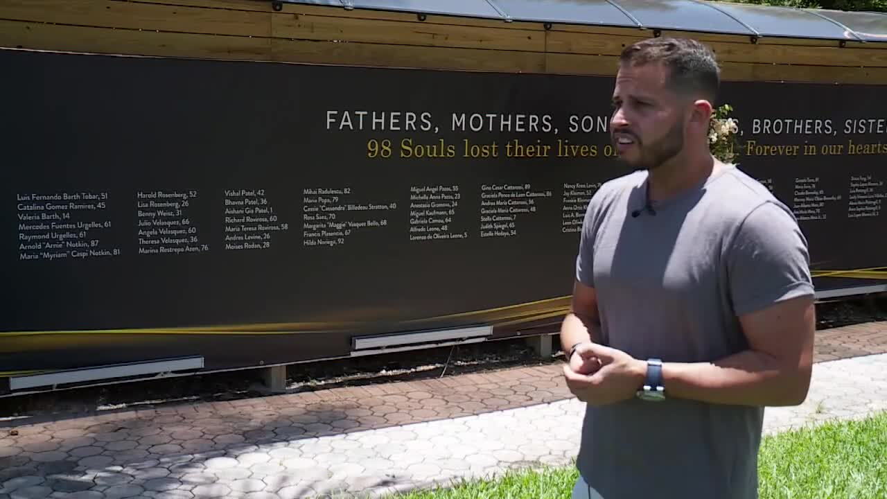 Michael Noriega stands in front of memorial for victims of Surfside condo collapse 1 year later
