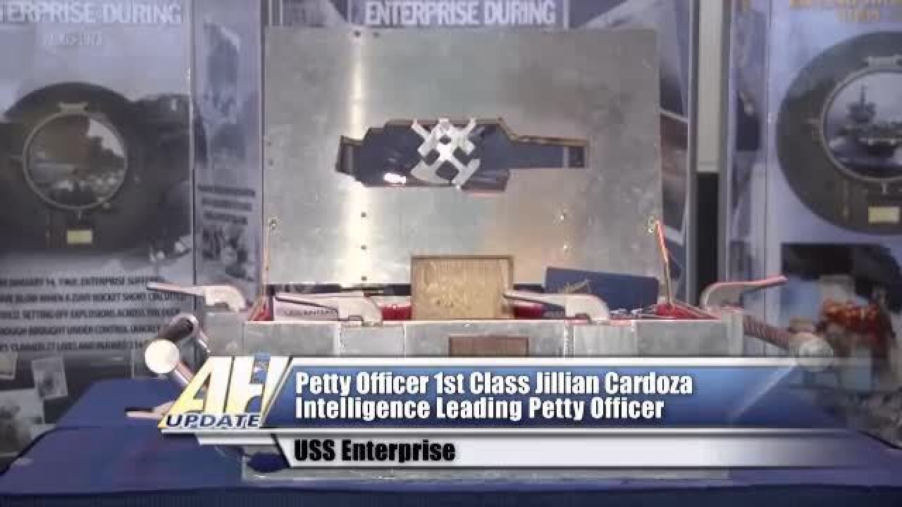 Sailors aboard the USS Enterprise prepare a time capsule