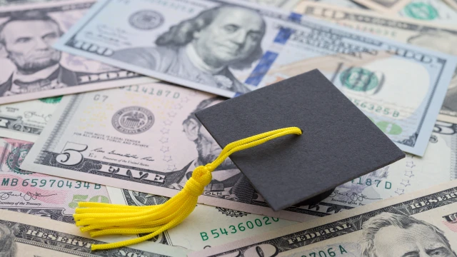 A graduation cap and money