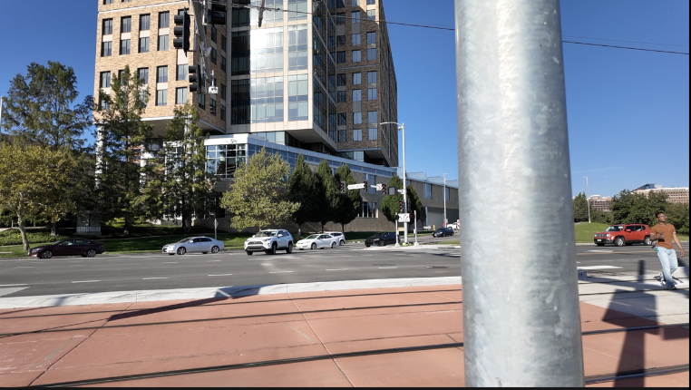 SUV narrowly missing a UMKC student who was walking on a pedestrian crosswalk along Streetcar extension. .png