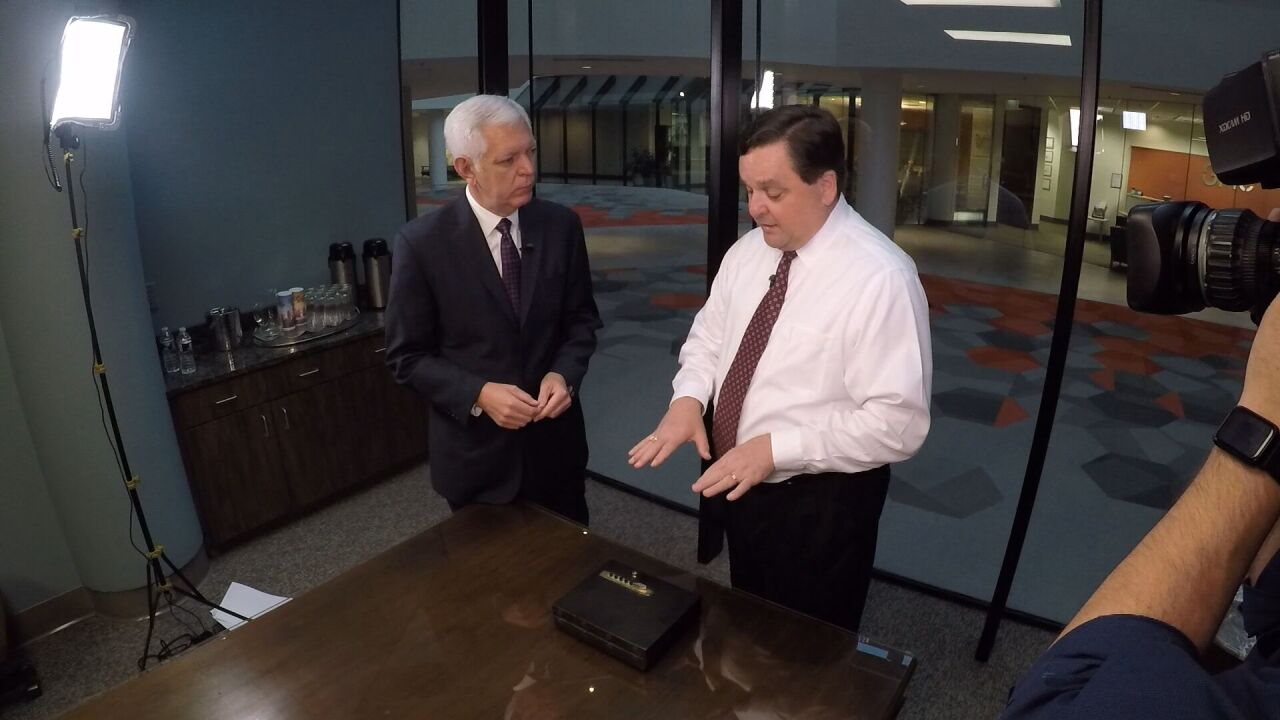 John Harris shows gun locking device.jpeg