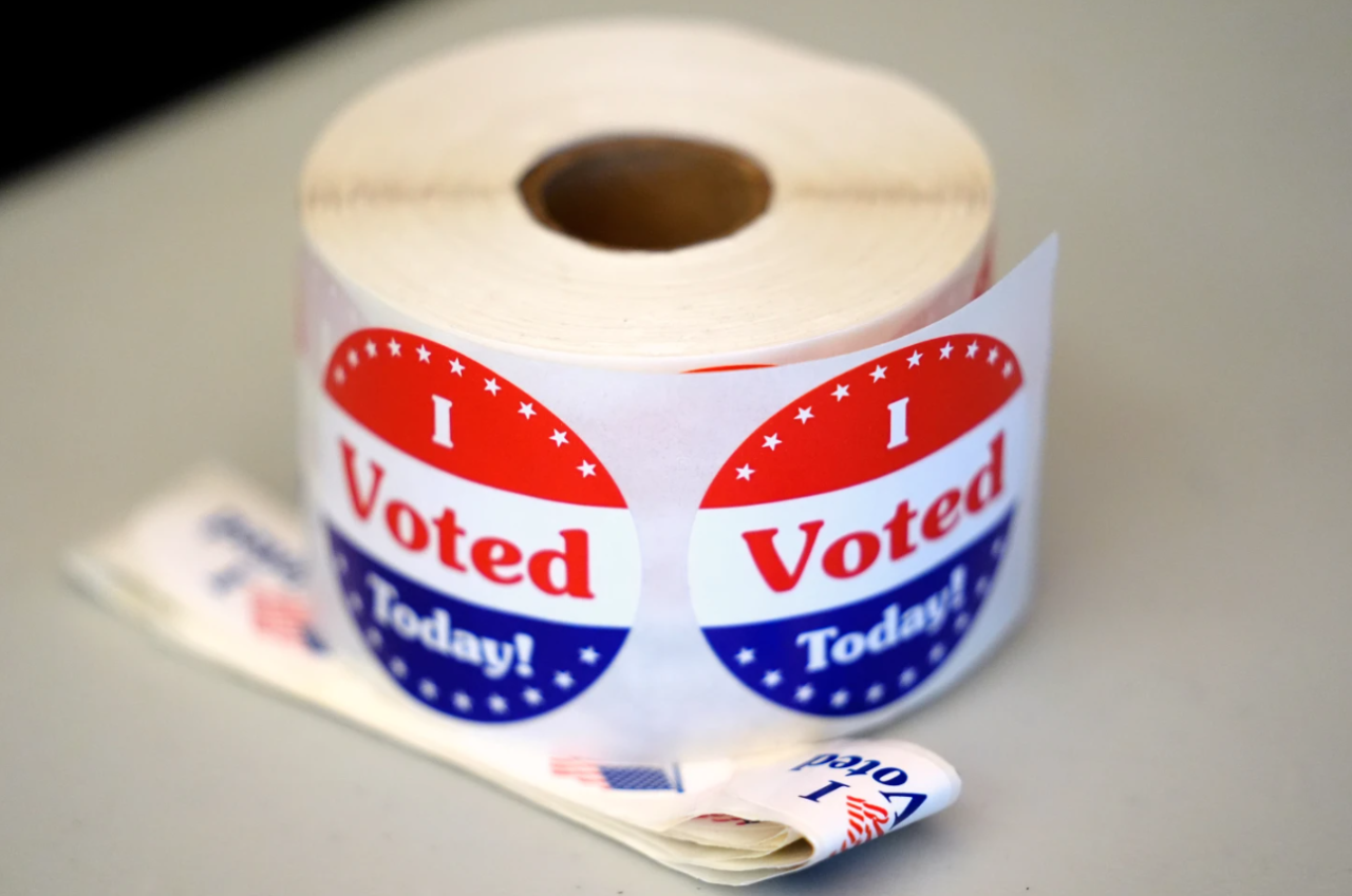 A spool of stickers rests on a table at a polling station during Massachusetts state primary voting, Sept. 3, 2024, at the Newton Free Library, in Newton, Mass.