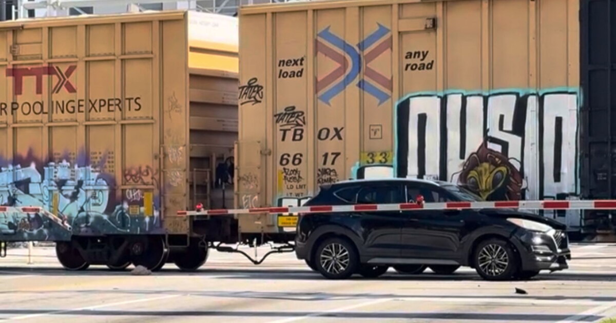 Train strikes car stuck on tracks near Banyan Boulevard; expect delays
