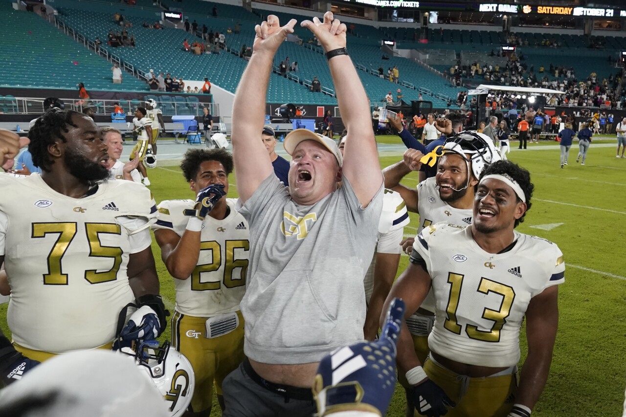 Georgia Tech Yellow Jackets head coach Brent Key celebrates with team after beating Miami Hurricanes, Oct. 7, 2023