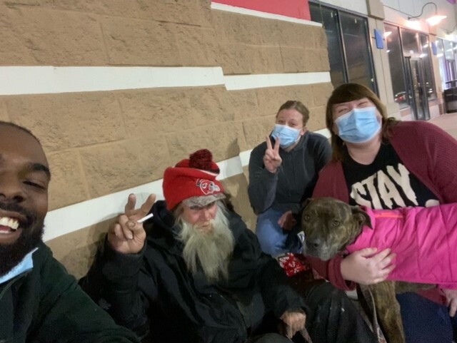 Aaron, Rabbit, Steph, Jessica and Sadie outside the store. The peace signs were Rabbit's request.