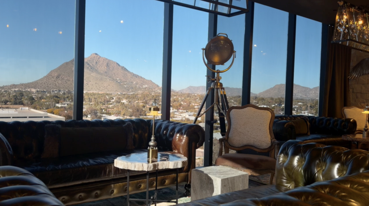 The lounge area, which can be reserved for private events, is furnished with couches and provides guests with views of Camelback Mountain.