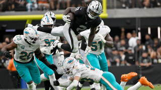 Las Vegas Raiders running back Ashton Jeanty (2) leaps over Miami Dolphins linebacker Jordyn Brooks (20) and safety Zayne Anderson (23) during the second half of an NFL football game, Sunday, Sept. 13, 2026, in Las Vegas. 