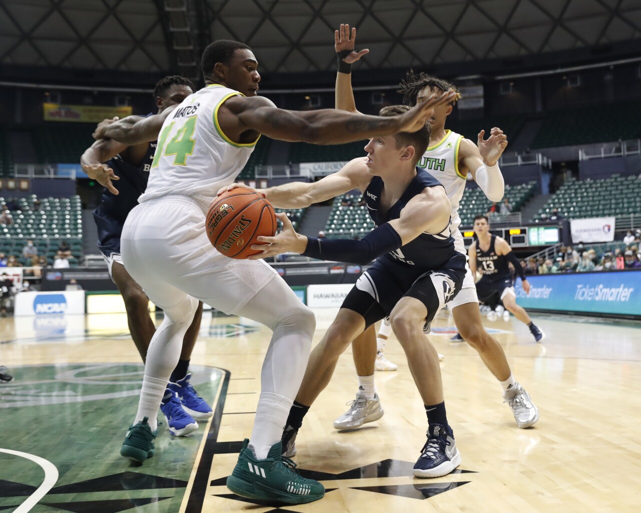 BYU Cougars guard Spencer Johnson makes pass around South Florida Bulls forward Bayron Matos, Dec. 22, 2021