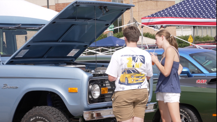 People looking at car