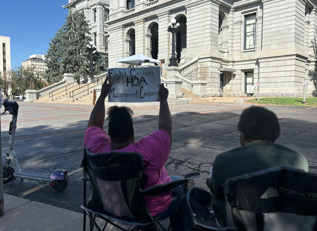 people hold up sign.png