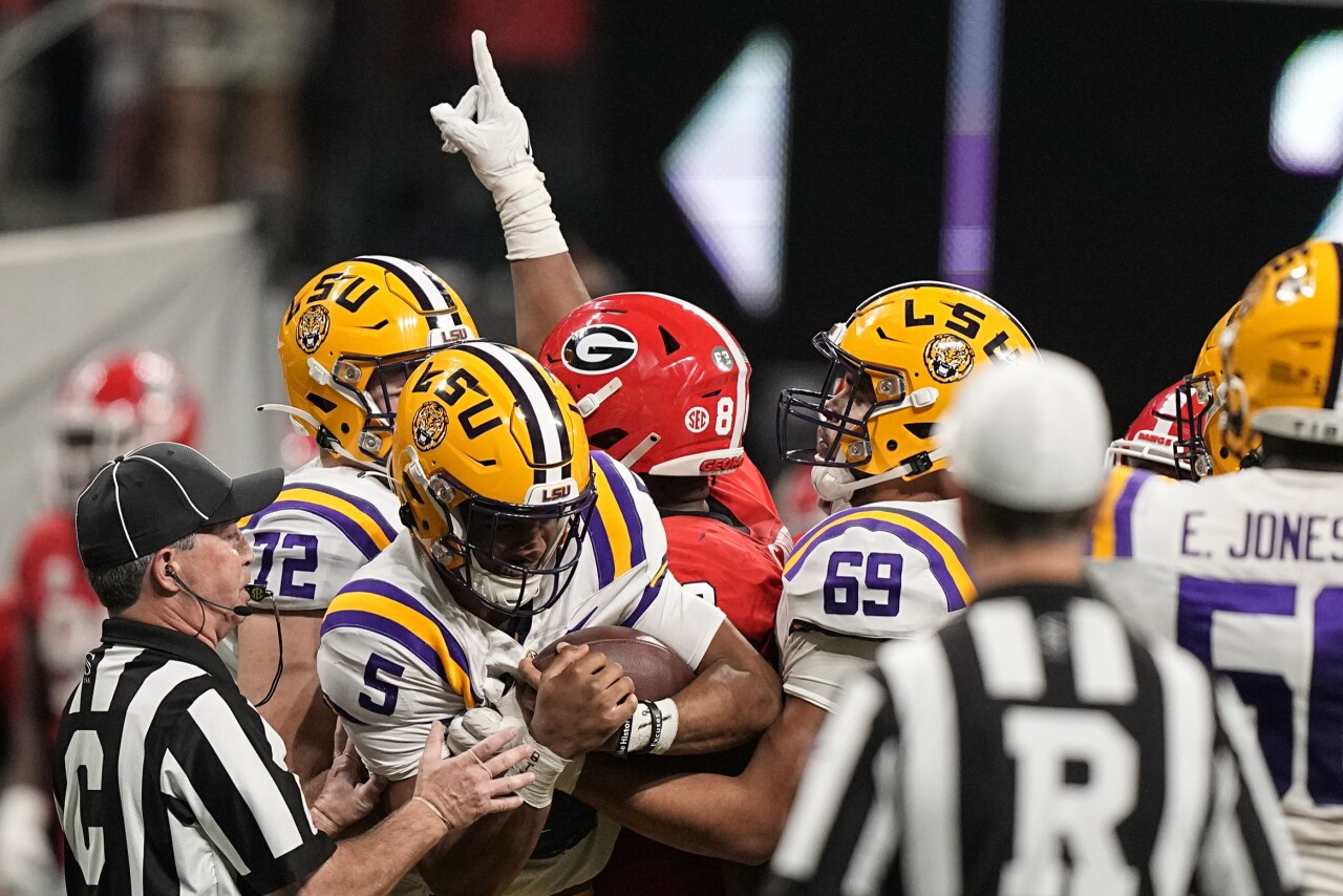 LSU Tigers QB Jayden Daniels held by by Georgia Bulldogs defensive lineman Jalen Carter in 2022 SEC Championship