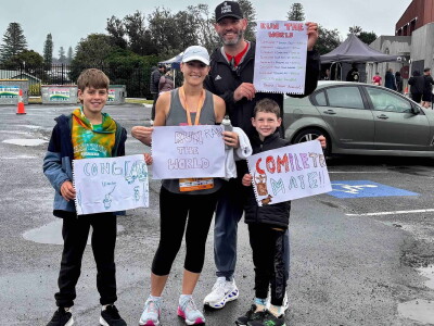 Katie Virtue with her family after completing her 7th and final race on every continent