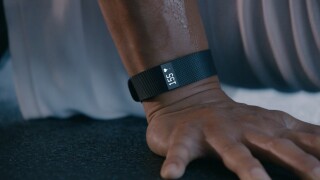 Man wears a Fitbit Charge HR