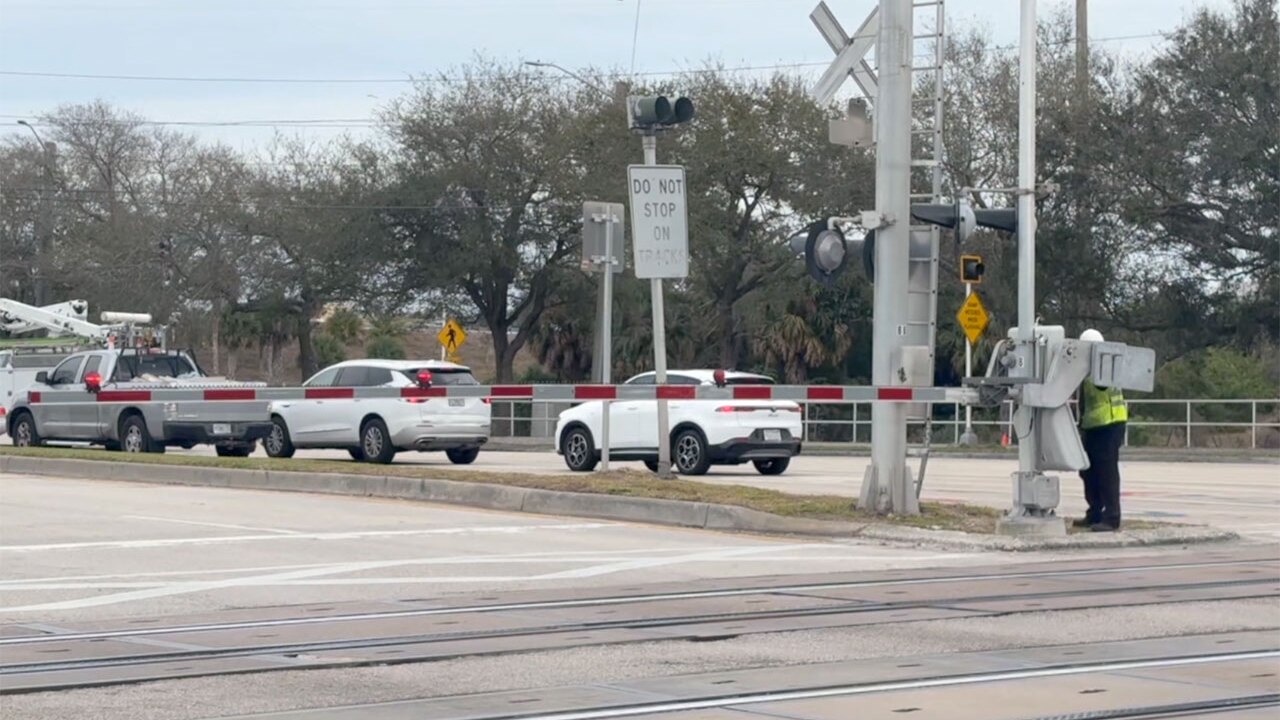 Railroad crossing gates on Palmetto Road near Interstate 95 in Boca Raton.