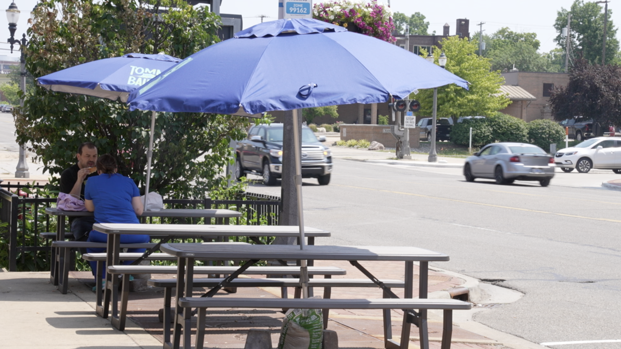 People are sitting outside GoodFellas Bagel & Deli