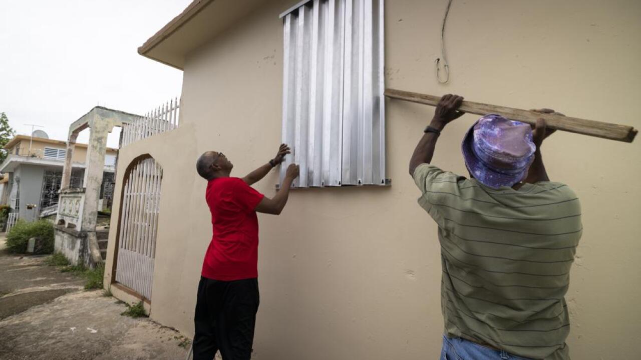 Residents prepare for the arrival of Tropical Storm Fiona, in Loiza, Puerto Rico, Saturday, Sept. 17, 2022. Fiona was expected to become a hurricane as it neared Puerto Rico on Saturday, threatening to dump up to 20 inches (51 centimeters) of rain as people braced for potential landslides, severe flooding and power outages. (AP Photo/Alejandro Granadillo)
