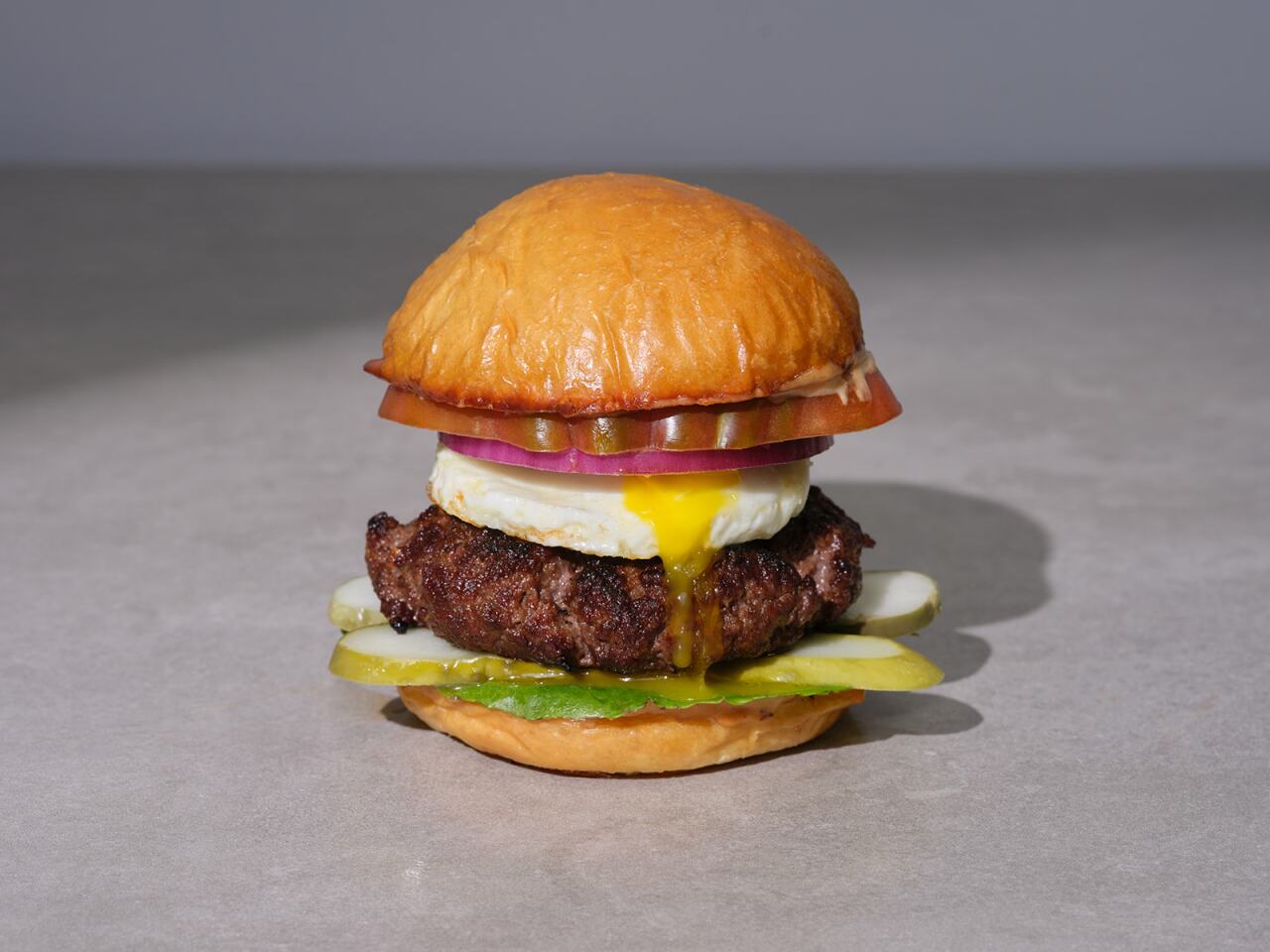 Photo features 'Angie's USDA Prime Steakhouse Burger with Egg.'