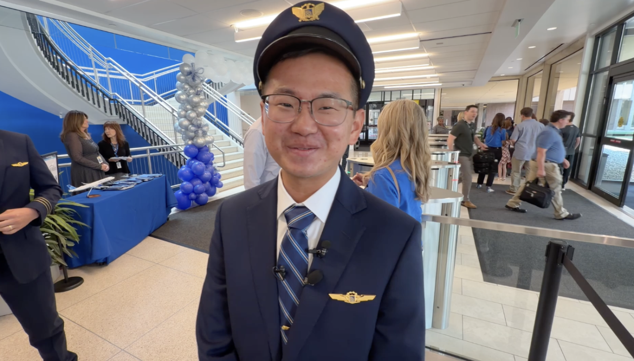 United Airlines First Officer Kai Rackley showing Make a Wish families around the Flight Training Center