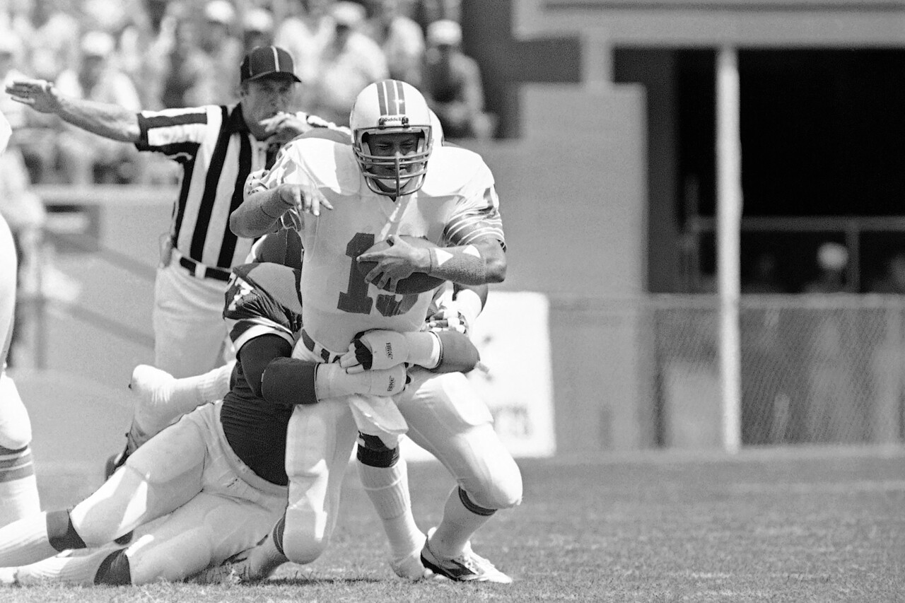 Miami Dolphins QB Dan Marino sacked by Buffalo Bills defensive end Ben Williams in first quarter, Oct. 9, 1983